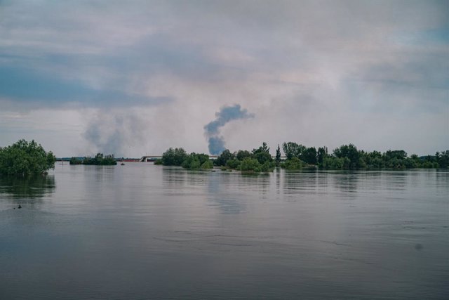 June 7, 2023, Kherson, Kherson, Ukraine: On the outskirts of the town of Kherion, Antonivka. The Antonivtsky bridge destroyed during the Ukrainian offensive in autumn 2022, the Dnieper raw and on the other bank occupied by the banks the columns of smoke r