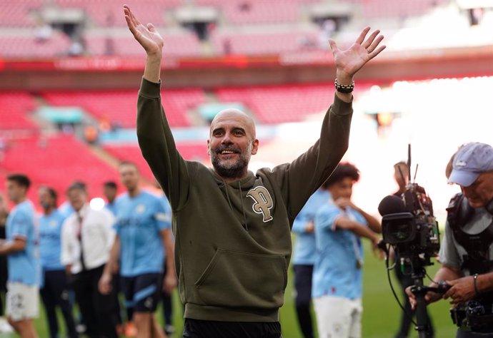 03 June 2023, United Kingdom, London: Manchester City manager Pep Guardiola waves to the fans after winning the English FA Cup final soccer match between Manchester City and Manchester United at Wembley Stadium. Photo: Adam Davy/PA Wire/dpa