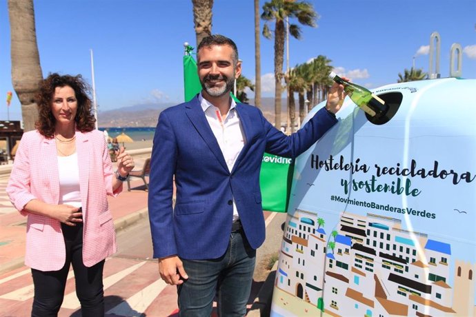 El consejero de Sostenibilidad, Medio Ambiente y Economía Azul, Ramón Fernández-Pacheco, junto a la alcaldesa de Almería, María del Mar Vázquez, deposita vidrio en una cuba en la presentación en Andalucía de la iniciativa 'Banderas Verdes' de Ecovidrio. 