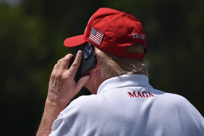 May 27, 2023, Sterling, Virginia, United States: Former President of the United States Donald J. Trump takes a phone call as he visits the driving range. Former President of the United States Donald J. Trump visits the driving range, meets fans and watche