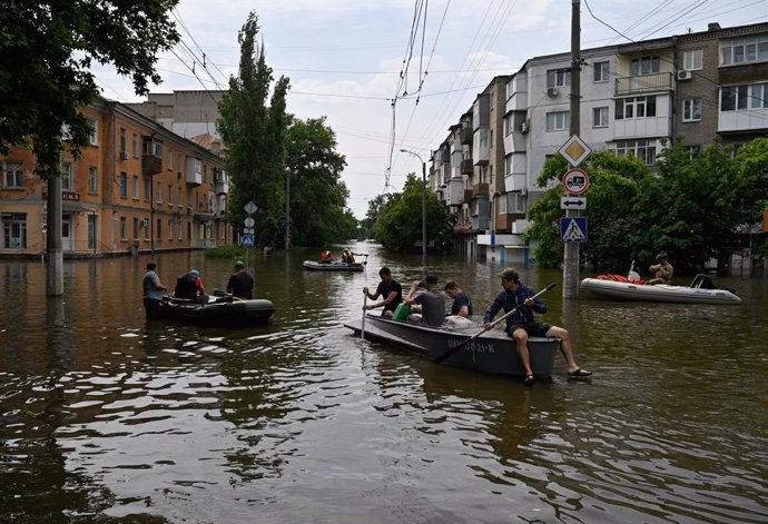 June 8, 2023, Kherson, Ukraine: Volunteers float in a boat during an evacuation of local residents from a flooded area of Kherson. On June 6, the Russian army blew up the dam of the Kakhovka hydroelectric power station. As a result of the explosion dam,