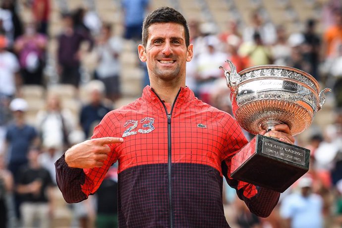 11 June 2023, France, Paris: Serbian tennis player Novak Djokovic celebrates with the trophy following his victory over Norwegian Casper Ruud during their men's singles final match of the Roland-Garros Open tennis tournament at the Court Philippe-Chatri