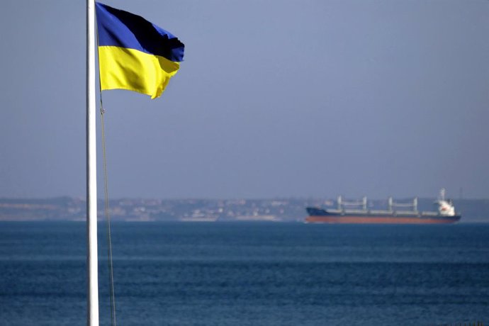 Archivo - December 29, 2022, Odesa, Ukraine: The flag of Ukraine against the background of a ship moored in the port of Odesa within the framework of the grain corridor, Odesa, southern Ukraine.