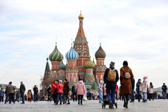 May 19, 2023: Moscow, Russia - April 2023: Crowd of people walking on Red square in Moscow in spring. View to the St. Basil's Cathedral and tourists