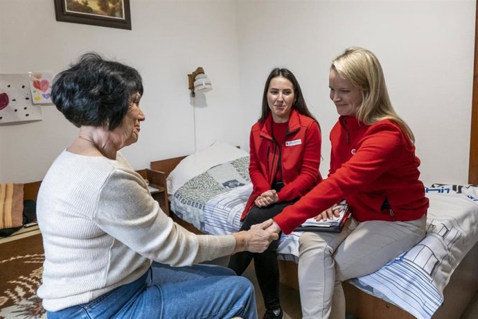 Voluntarias de Cruz Roja, con una persona refugiada