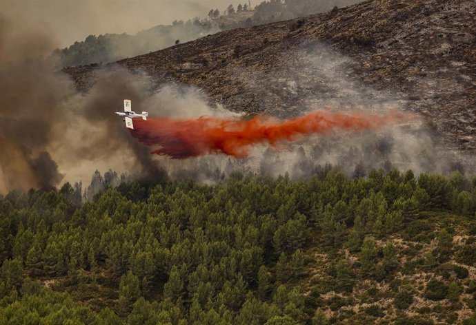 Archivo - Imagen de archivo de un medio aéreo trabajando en la extinción de uno de los incendios forestales declarados el pasado verano en la Comunitat Valenciana., 