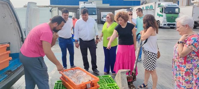 Los cabezas de lista al Congreso y Senado de las elecciones generales del 23J, Gabriel Cruz y María Eugenia Limón, respectivamente, junto a varios componentes de las candidaturas, en su visita a la lonja de Punta Umbría.