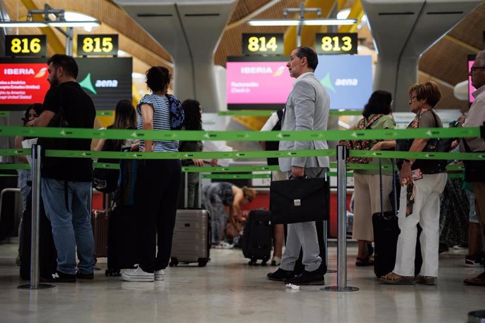 Varios pasajeros en una fila de Iberia en la Terminal T4 del Aeropuerto Adolfo Suárez-Madrid Barajas, a 21 de junio de 2023, en Madrid (España).