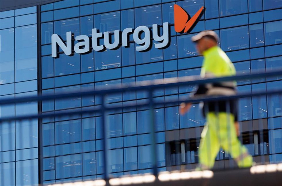 Archivo - Una persona camina frente a la sede de Naturgy, a 4 de abril de 2023, en Madrid (archivo)