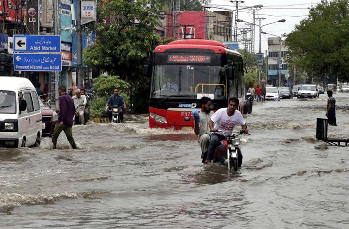 July 5, 2023, Pakistan: LAHORE, PAKISTAN, JUL 05: Commuters are facing difficulties in transportation due to .stagnant rainwater due to poor sewerage system caused by heavy downpour of monsoon season, .at Queens road in Lahore on Wednesday, July 5, 2023