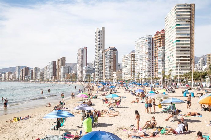 Archivo - Numerosas personas se bañan y toman el sol en la playa de Poniente, a 11 de marzo de 2023, en Benidorm