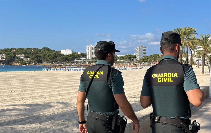 Archivo - Dos agentes de la Guardia Civil en una playa de Mallorca.