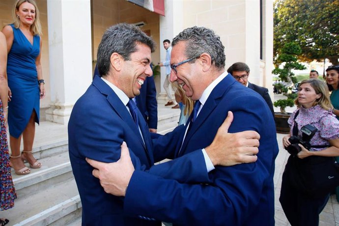 El presidente de la Generalitat, Carlos Mazón (i), saluda al alcalde de Benidorm y futuro presidente de la Diputación de Alicante, Toni Pérez (d), a su llegada a la primera reunión del Pleno del Consell, en el Museo Arqueológico de Alicante MARQ