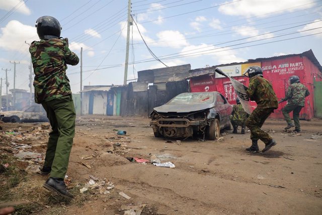 July 20, 2023, Nairobi, Kenya: Police officers take cover while dispersing protesters during day two of a protest called by Azimio party leader Raila Odinga over the high cost of living in Kibera Slums.