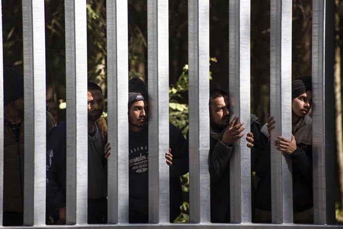 Archivo - May 28, 2023, Bialowieza, Podlaskie, Poland: Migrants with children seeking asylum are seen at the Belarusian side of the Polish border wall in Bialowieza. A group of 30 migrants and refugees from Iraq and Syria seeking asylum, including more 