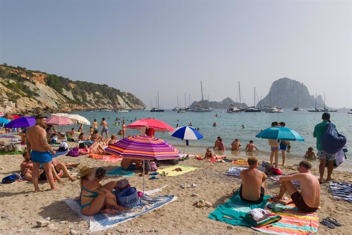 Varias personas en la playa de Cala d'Hort, a 11 de julio de 2023, en Ibiza, Islas Baleares (España). 