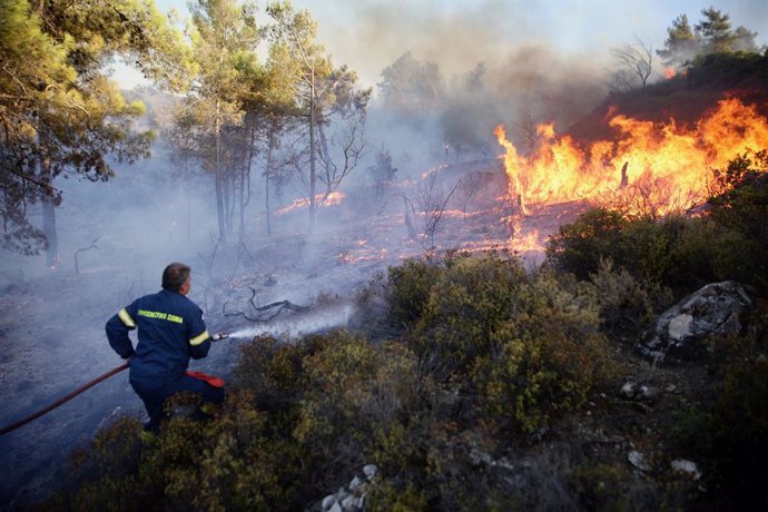 July 23, 2023, Rhodes island, Greece: A firefighter tries to put out a wildfire in Asklipio village, on Rhodes island. Local people and tourists have been evacuated from area after wild fires broke out on the island of Rhodes, Greece
