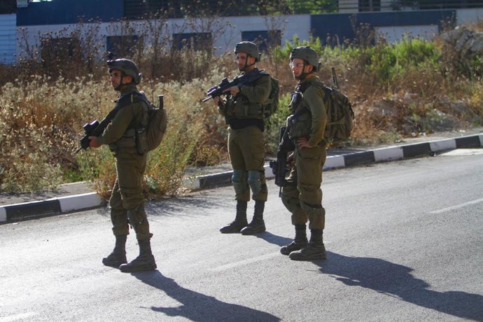 July 25, 2023, Nablus, West bank, Palestine: Israeli soldiers stand guard while securing the scene of the shooting in which three Palestinians were shot dead by the Israeli army, near Nablus, in the northern West Bank. An Israeli force opened fire on a 