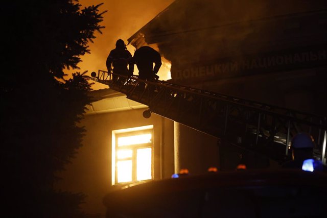 DONETSK, Aug. 6, 2023  -- Firemen try to put out fire at a building in Donetsk, Aug. 5, 2023. A woman has died and two men have been injured following a Ukrainian attack on Donetsk's Kuibyshev district, Donetsk Mayor Alexey Kulemzin said Sunday.    Kulemz
