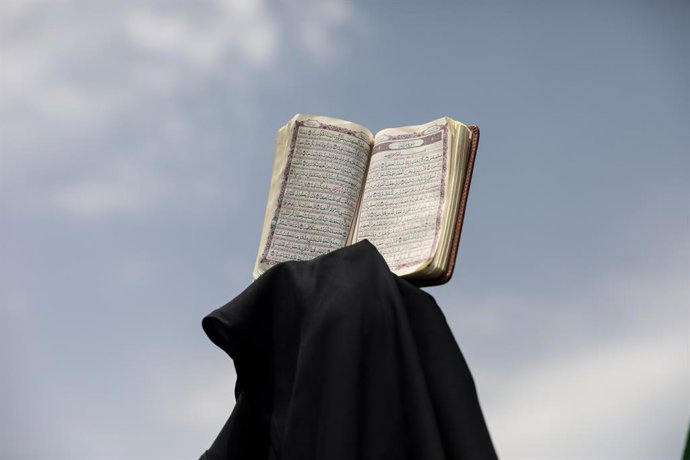 July 21, 2023, Tehran, Tehran, Iran: An Iranian demonstrator holds up a copy of Quran, Islam's holy book, during a protest of the burning of a Quran in Sweden, in Tehran, Iran, Friday, July 21, 2023. On Thursday, a man who identified himself in Swedish 