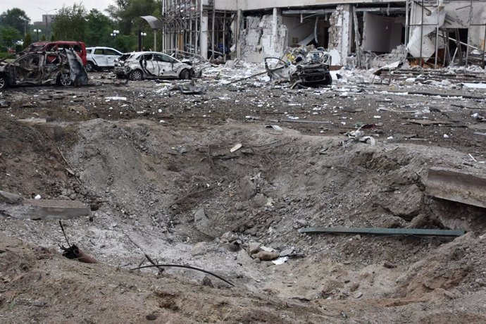 August 11, 2023, Zaporizhzhia, Ukraine: A crater after missile attack seen by the heavily damaged 'Reikartz' hotel and destroyed car on the hotel parking following Russian rocket attack in Zaporizhia. A Russian missile struck a hotel in the Ukrainian ci