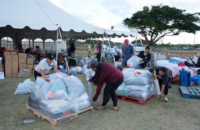 August 11, 2023 - Kuta, Hawaii, USA - Volunteers palletize and wrap enormous quantities of supplies freely donated by the Maui community and beyond. The donations range from soup to nuts and everything in betweenclothing, household items, first aid sup