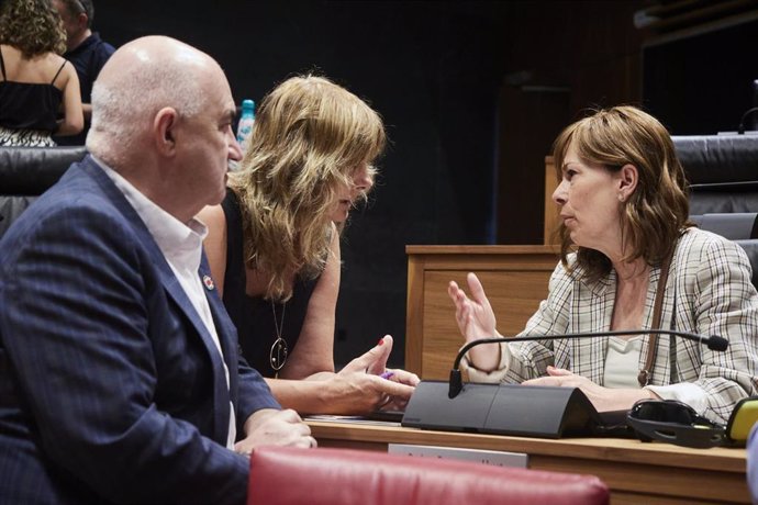 La portavoz de Geroa Bai, Uxue Barkos (d), conversa con el vicepresidente segundo del Gobierno de Navarra en funciones, José María Aierdi, y con la consejera de Relaciones Ciudadanas, Ana Ollo, en el debate de investidura de María Chivite.