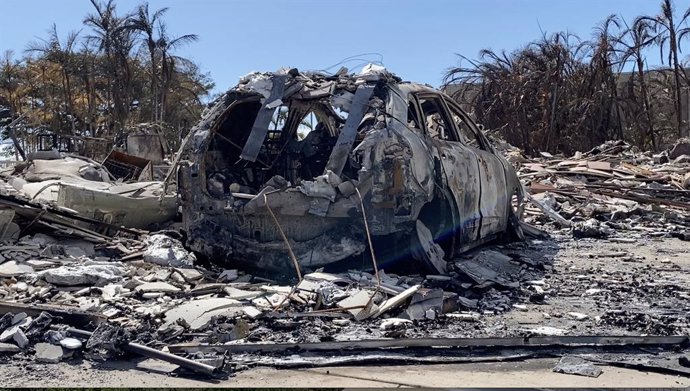 LAHAINA (U.S.), Aug. 15, 2023  -- The photo taken with a mobile phone on Aug. 14, 2023 shows a vehicle destroyed in a wildfire in Lahaina town, Maui Island, Hawaii, the United States. The death toll from the Maui wildfires reached 99, authorities said M
