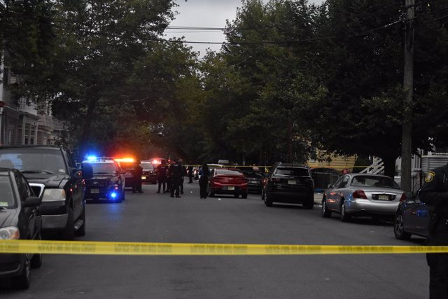 August 17, 2023, Newark, New Jersey, United States: Wide view of the crime scene on South 20th Street and 18th Avenue. Occupants of two vehicles were shooting at each other. Bullets struck a man and the male was pronounced dead. The male was found laying 