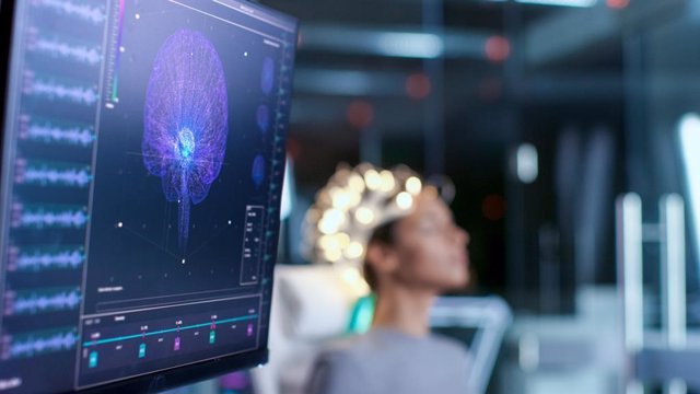 Mujer con electrodos en la cabeza en un laboratorio.