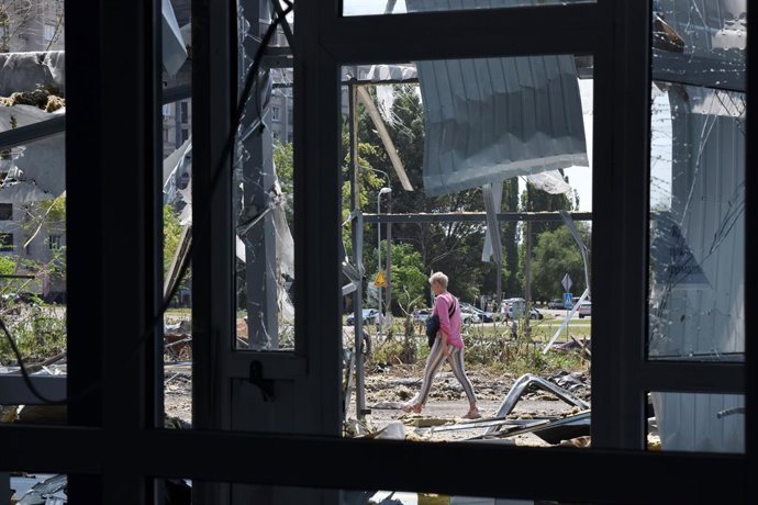 Archivo - 15 July 2023, Ukraine, Zaporizhia: A woman walks next to a building heavily damaged by Russian shelling in Zaporizhzhia. Photo: Andriy Andriyenko/SOPA Images via ZUMA Press Wire/dpa