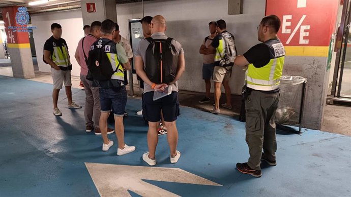 Agentes de la Policía Nacional junto a los tres detenidos.