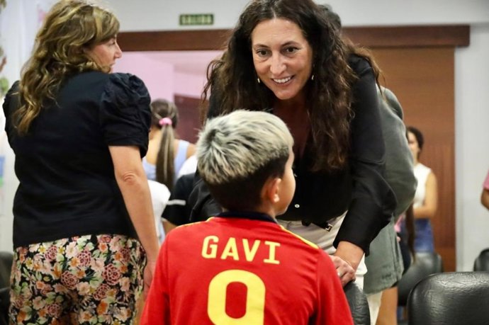 La consejera de Inclusión Social, Juventud, Familias e Igualdad, Loles López, charla con un menor.