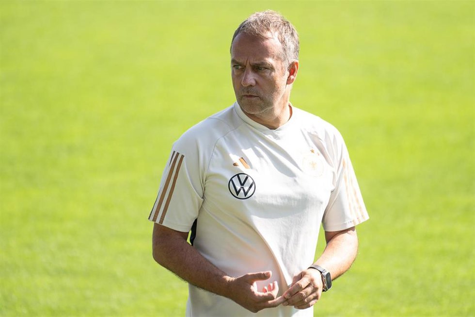 German coach Hansi Flick walks around the ground during a training session.