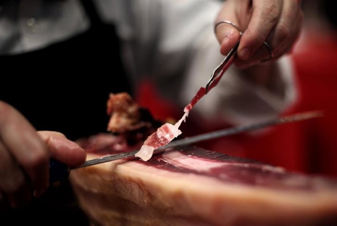 Archivo - Un cortador de jamón prepara tapas durante la segunda jornada de la Feria Internacional de Turismo- FITUR 2020, en Madrid (España), a 23 de enero de 2020.