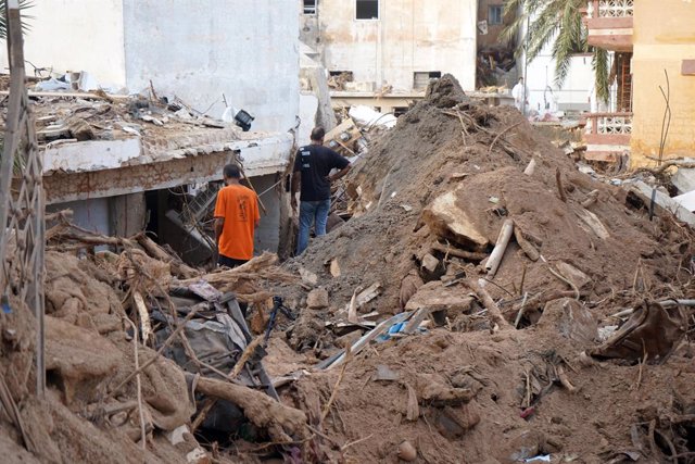 DERNA, Sept. 17, 2023  -- This photo taken on Sept. 16, 2023 shows people standing amid debris in Derna, Libya. On Sept. 10, Mediterranean storm Daniel made landfall in Libya, bringing heavy storms and flash floods along its path in the northeast of the w