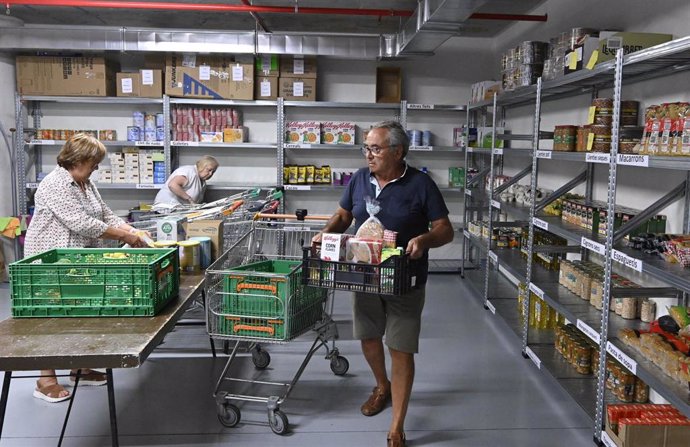 Un voluntario prepara un lote de alimentos básicos