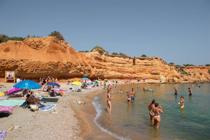 Archivo - Varias personas en la playa de Cala d'Hort, en Ibiza.