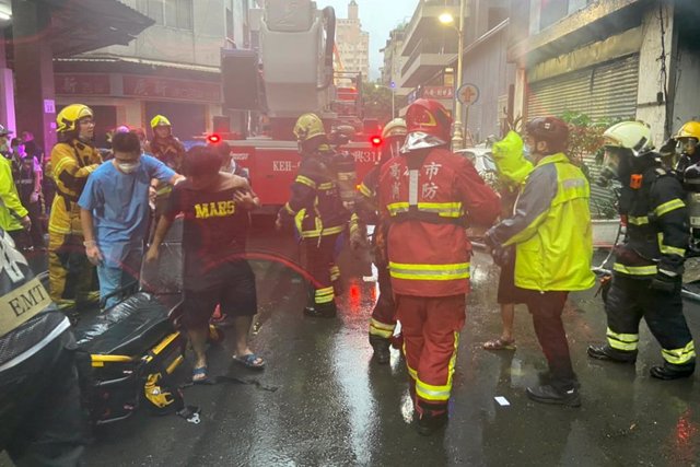 October 13, 2021, Kaohsiung, Taipei City, Taiwan: Fire fighters and rescuers conducting rescue operations outside a building in a downtown area of Kaohsiung that has been engulfed in huge fire, with at least 7 deaths dozens of them injured, according to l