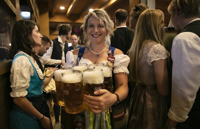 MUNICH, Sept. 17, 2023  -- A staff member serves beer at the Oktoberfest in Munich, Germany, Sept. 16, 2023. The 188th Oktoberfest, one of the largest folk festivals in Germany, officially opened here on Saturday. It is expected to conclude on Oct. 3.