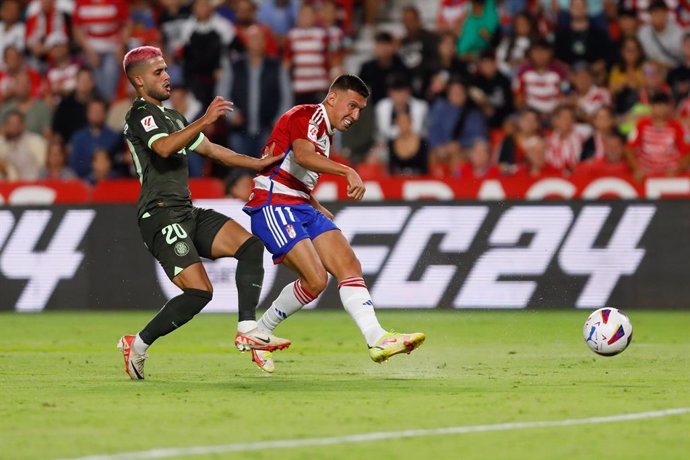 Myrto Uzuni of Granada CF  and Yan Couto of Girona FC in action during the Spanish league, La Liga EA Sports, football match played between Granada CF and Girona FC at Nuevo Los Carmenes stadium on September 18, 2023, in Granada, Spain.