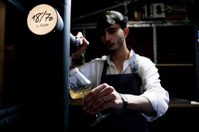 Archivo - Un camarero tira una cerveza de barril.