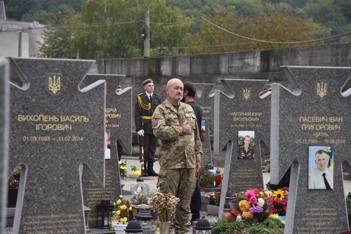 October 1, 2023, Lviv, Ukraine: A soldier honors the memory of his comrades in service who were killed during the Russian-Ukrainian war at the Lychakiv Cemetery in Lviv on Defender of Ukraine Day.