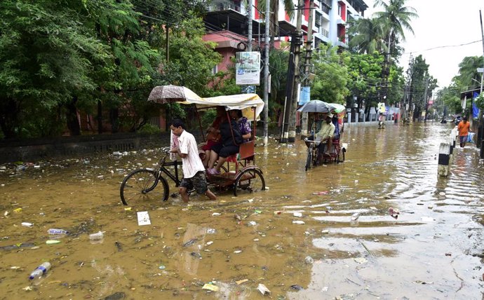 October 5, 2023, Guwahati, Guwahati, India: Rickshaw puller  wades through the water flooded street after rain  in Guwahati Assam India on Thursday 5th October 2023.