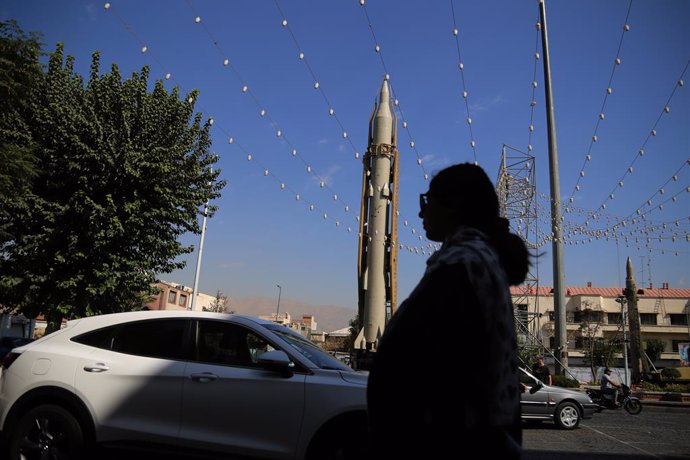 September 26, 2023, Tehran, Iran: An Iranian woman moves past an Iranian Sejjil solid-fueled medium-range ballistic missile, during a military exhibition commemorating the Iran-Iraq war (1980-88) anniversary, at Baharestan Square in downtown Tehran. Mil