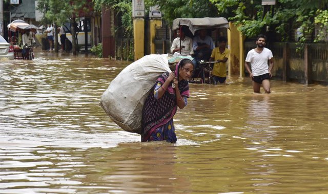 October 6, 2023, Guwahati, Guwahati, India: A woman wades through the   flooded area  after heavy rain in Guwahati Assam India on Friday 6th October 2023.