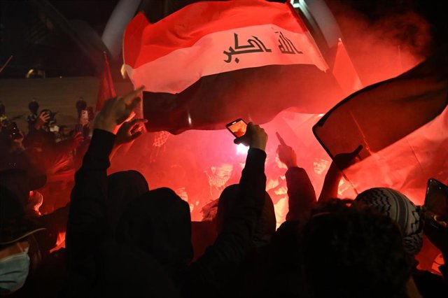 Participants of a Free Palestine rally react as flares are lit outside the Sydney Opera House in Sydney, Monday, October 9, 2023. Israel has pounded the Palestinian enclave of Gaza, killing hundreds of people in retaliation for one of the bloodiest attack
