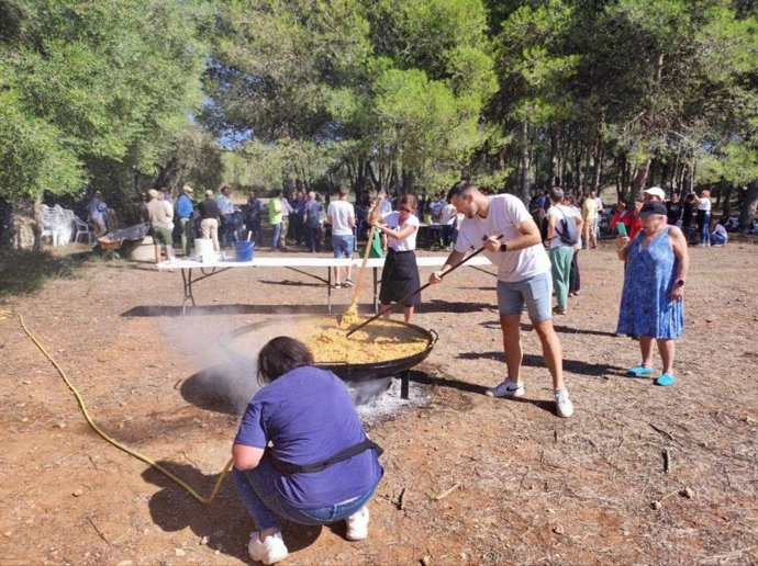 Un hombre cocina una gran paella durante la celebración del 20 aniversario de Casa de Familia al servicio de la Red de Inserción Social del IMAS.
