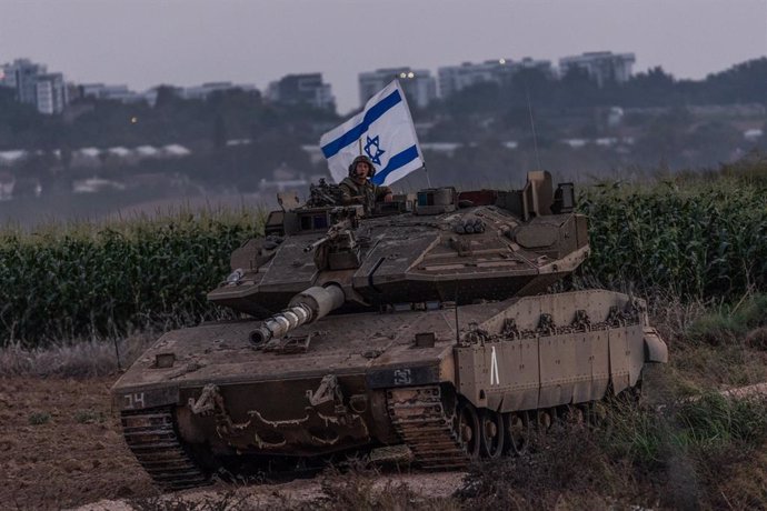 12 October 2023, Israel, Sderot: An Israeli soldier on a tank is seen near the Israel-Gaza border. Photo: Ilia Yefimovich/dpa