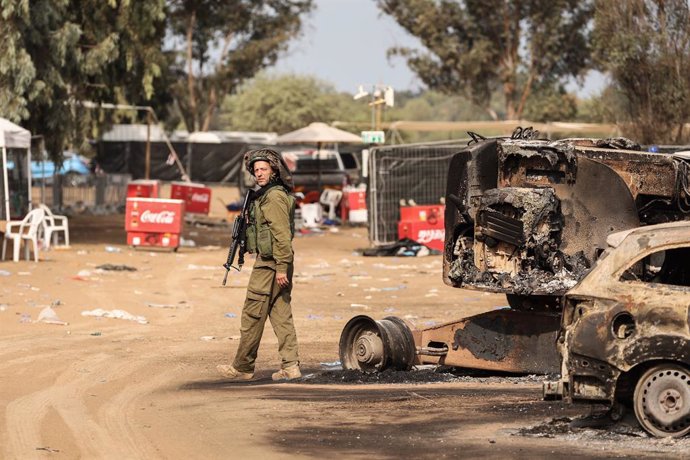 Israel, Re'im: An Israeli solider stands at the grounds of the Supernova electronic music festival after Saturday's deadly attack by Islamist Hamas militants where 260 people died and more than 100 people were taken hostage 
